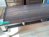 Top view of the wooden coffee table showing the medium brown finish and surface wear.