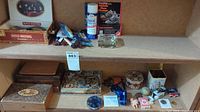 Wide view of the shoe cleaning supplies, shoelaces, cigar box, and other small items on a shelf
