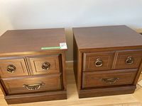 Two brown wood night tables side by side showing front and handles.