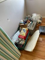 Overview of ironing boards, totes, and sewing patterns and notions on floor