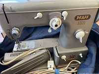 Side view of Pfaff 332 sewing machine showing model decal, controls, and body
