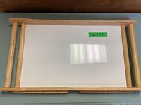 Top view of wooden bed tray showing white flat surface and wood frame.