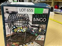 Deluxe Bingo game box showing product image with metal cage and bingo balls illustration on front