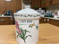 Front view of ceramic cookie jar showing floral pattern and lid.
