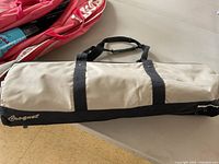 Soft-sided beige and black carry bag for croquet set with 'Croquet' branding.