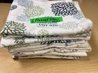 Stack of six folded flannel pillow cases showing floral and abstract patterns in various colors.