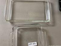 Two clear rectangular glass baking dishes, one large and one smaller with rounded corners, with Lot 391 sticker visible.