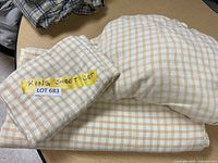 King size sheet set folded and labeled with 'KING SHEET SET' tape and lot sticker.