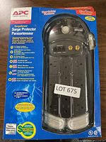 Front view of the APC SurgeArrest surge protector in its original packaging showing features and specifications.
