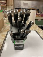 Front view of Farberware knife block with knives inserted showing handles and block front label.