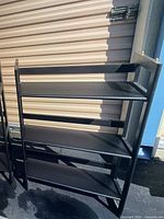 Front and side view of one 3-shelf black wooden bookshelf unit showing shelf spacing and side frame design.