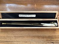 Set of tamper and pick resting in camphor wood box