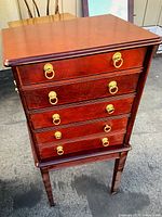 Full frontal view of the traditional wood dresser showing the top and front with five drawers and brass ring pulls