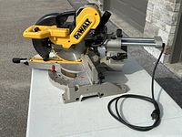 Front-left perspective on table showing saw assembly, blade guard and base