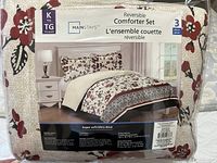 Image of the packaged comforter set with product label showing brand, size and reversible feature.