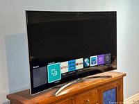 Front right perspective showing Smart Hub home screen with streaming app icons