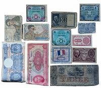 Photo showing 13 assorted vintage paper currency bills from several countries including South Carolina, USA, France, Germany, China, Italy, and UK, laid out on a white surface.
