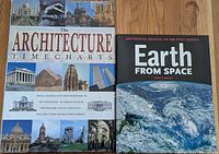 Two hardcover books placed side by side on wooden surface with covers visible: The Architecture Timecharts and Earth from Space.
