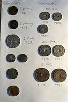 Coins from Germany and Denmark arranged with handwritten labels and dates, showing denomination and years from 1911 to 1941.