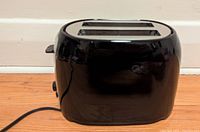 Front and side view of the Black and Decker 2-slice toaster showing black plastic body and stainless steel control panel with dial and lever.