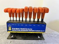Set of 10 metric T-handle hex keys in a black plastic holder with orange handles, sizes from 2mm to 10mm.