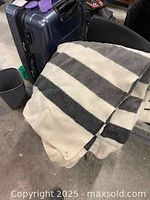 Full view of blanket draped to show stripe pattern and overall condition