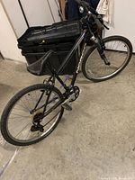 Full side view of the black Norco mountain bike showing frame, tires, saddle, and pedals.