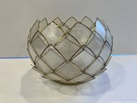 Side view of capiz shell bowl showing metal framing and shell panels forming petal pattern