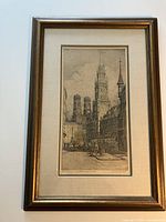 Framed etching showing Antwerp Cathedral with detailed architecture and street scene below