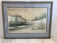 Full view of the framed landscape painting with snow-covered trees and bushes showing a winter scene.