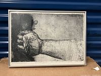 Full view of the framed etching showing the clenched fist and signature.