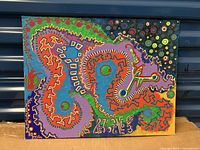 Front view of the abstract acrylic painting on board with vivid colors and shapes.