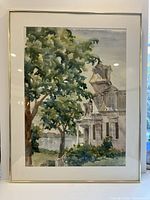 Framed watercolor painting of a house with tree by Dixie Clark, showing entire artwork with simple gold frame.