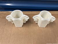 Pair of milk glass shaving mugs shown from top view highlighting cylindrical interior and wide opening