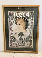 Framed Tosca poster with visible overall artwork including a woman, floral design and prominent Tosca title