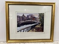 Front view of framed watercolor painting depicting a London river scene with a bridge and walkway along the Thames, signed by the artist.