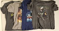 Four men's large Star Wars T-shirts laid out side by side showing all designs and colors.