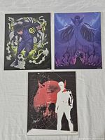 Three 8x10 art prints sealed in plastic, featuring anime and Marvel Daredevil themes, visible numbering in bottom right