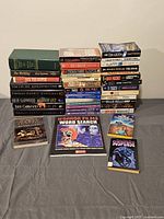Overall view of 29 books including horror, mystery, and suspense genres alongside a puzzle book and tote bag.