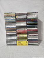 Three columns of stacked used CDs showing titles from classical and orchestral genres including composers and pieces by Beethoven, Berlioz, Vivaldi, and others.