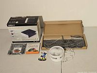 Lot laid out: external DVD-RW box, keyboard in box, mouse, USB fan, various cables and DVD-R media