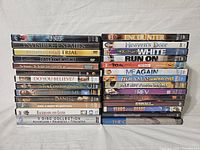 Stack of 26 used religious DVD movies arranged in two columns, visible titles listed.