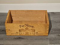 Front view of wooden wine crate showing Far Niente Napa Valley 2001 Chardonnay text and winery illustration.