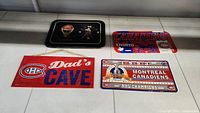 Four Montreal Canadiens memorabilia items displayed, including clock, two metal signs, and wooden sign.