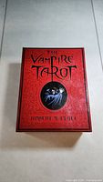 The Vampire Tarot red box with vampire image and gothic lettering by Robert M Place