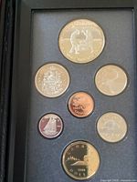Close-up of seven Canadian coins in proof condition displayed in foam case, showing details and finish