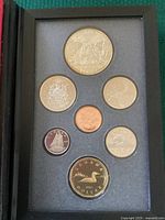 Set of 7 Canadian proof coins displayed in black foam holder showing detailed designs and patina.