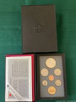 Set inside protective box with foam insert showing all coins including the large Stanley Cup themed dollar coin and other standard denominations.