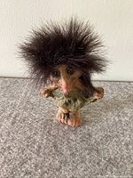 Front view of the Nyform Dancing Girl Troll figurine showing detailed facial features, wild dark fur hair, and green dress.