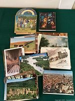 Stack of postcards showing various themes including scenic landscapes, stained glass art, religious and historical subjects from Europe.